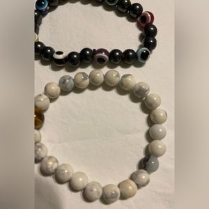 Two BOHO style bracelets center stone tiger’s eye; Evil eye grey tone bracelet